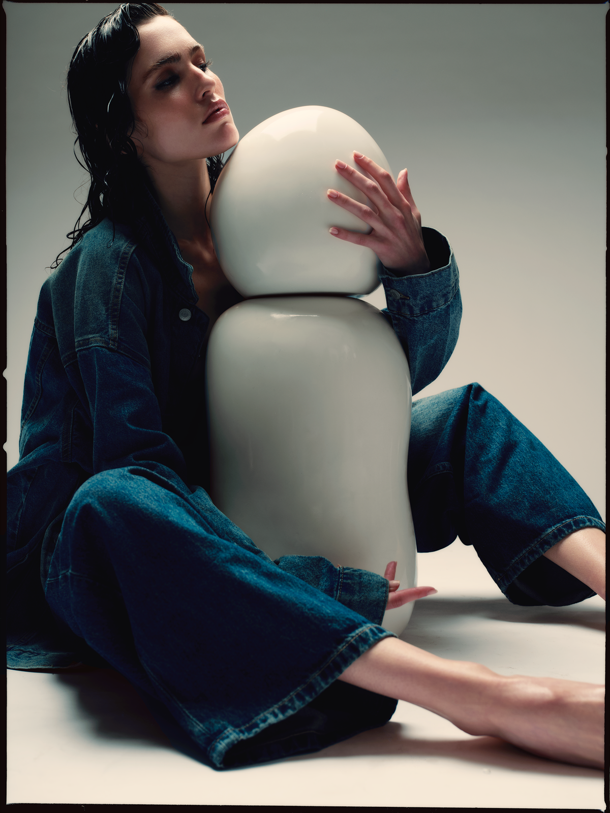 Model in denim embracing a large Ples'Jour® Opal bottle