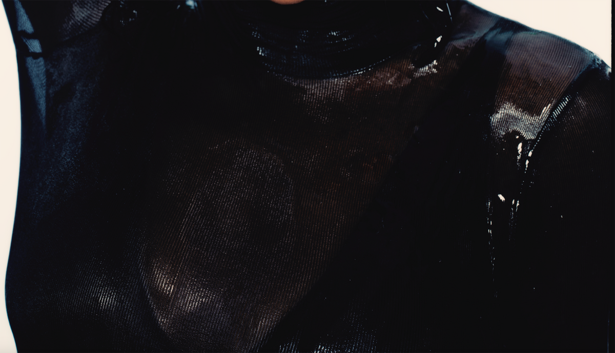 Woman in black glistening with Opal silicone lubricant